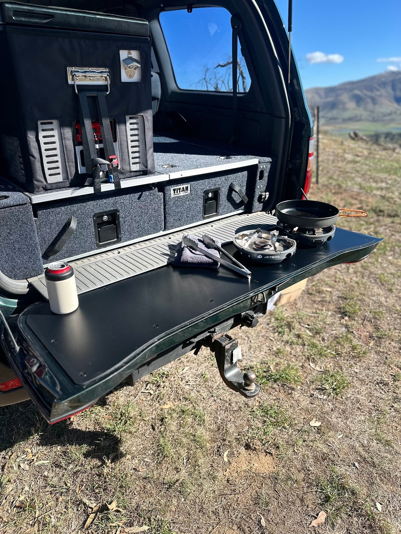 Durable tailgate food prep and cutting board fitted onto a LandCruiser 100/105 Series tailgate during a camping trip.