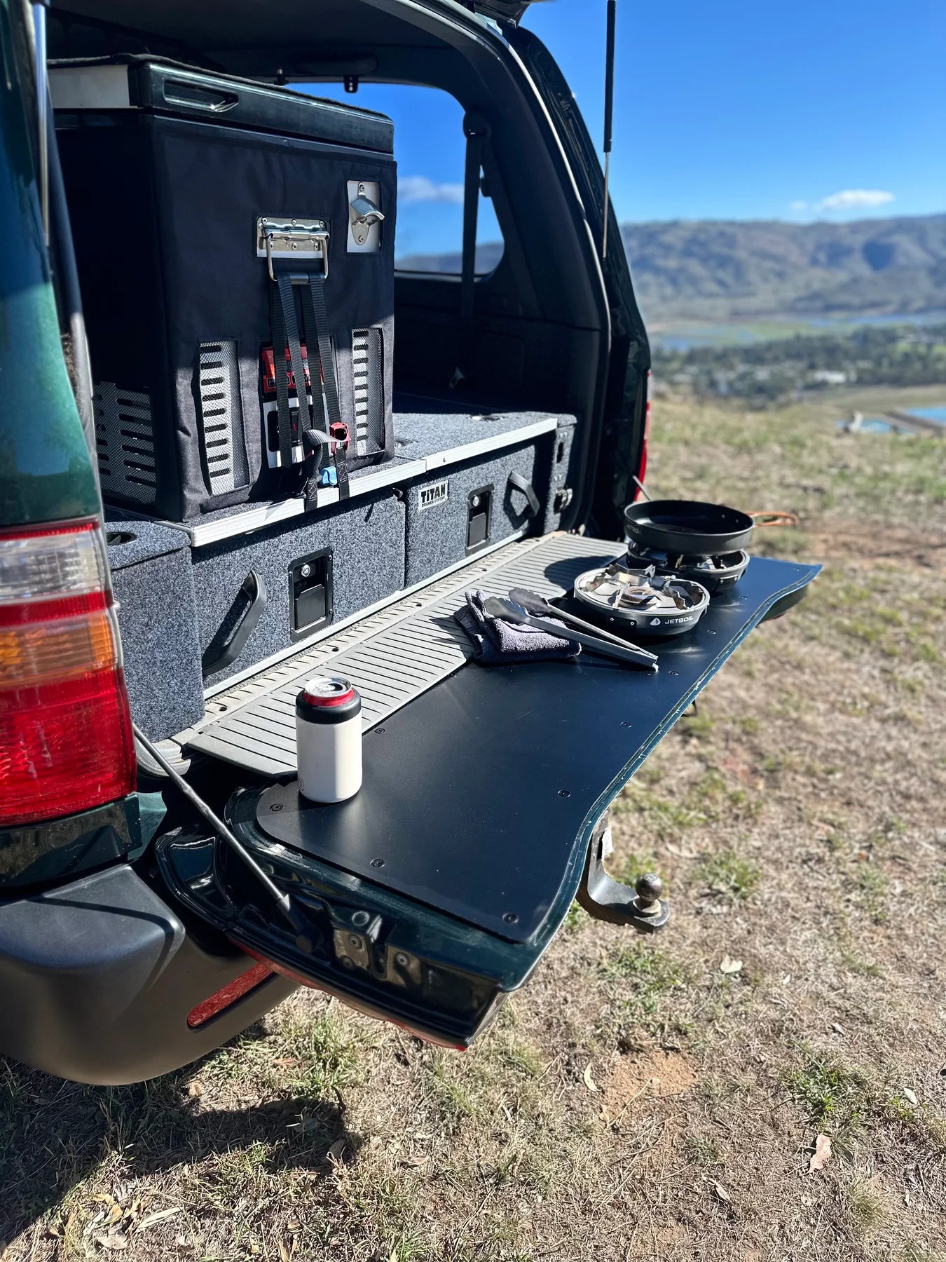Durable tailgate food prep and cutting board fitted onto a LandCruiser 100/105 Series tailgate during a camping trip.