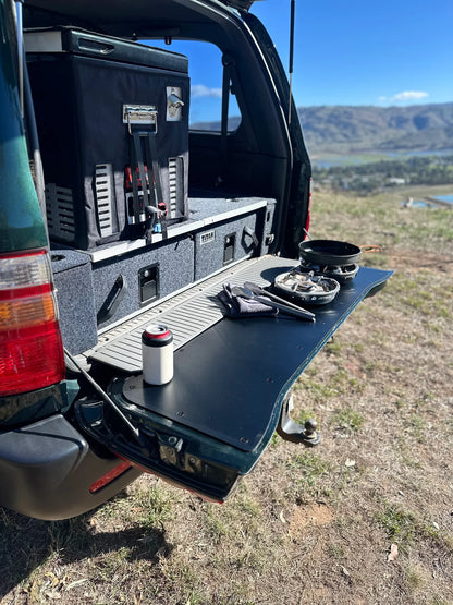 Durable tailgate food prep and cutting board fitted onto a LandCruiser 100/105 Series tailgate during a camping trip.