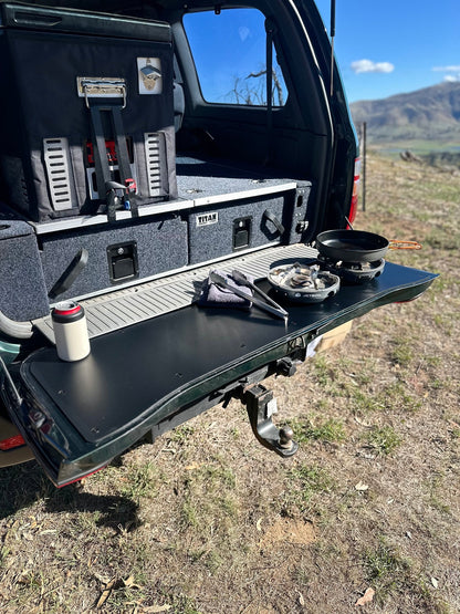 Durable tailgate food prep and cutting board fitted onto a LandCruiser 100/105 Series tailgate during a camping trip.